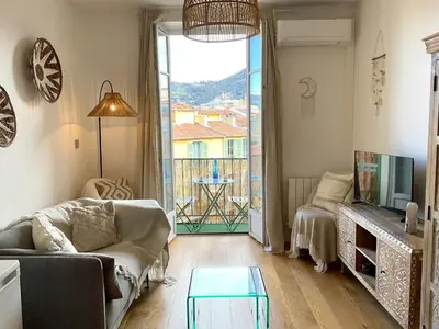 a living room with a couch and a tv at Le Garib in Nice