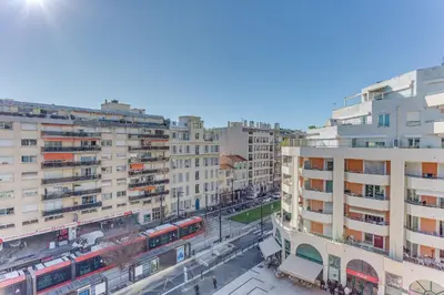 a view of a city with a train and buildings at PALAIS DES ARTS AP4399 By Riviera holiday homes in Nice