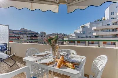 a white table and chairs on a balcony at PALAIS DES ARTS AP4399 By Riviera holiday homes in Nice