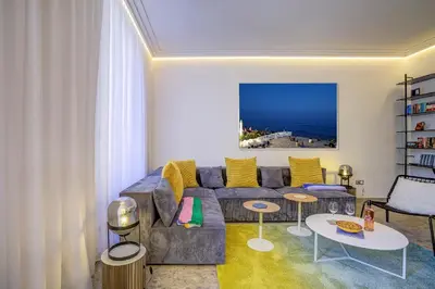 a living room with a couch and a table at Maison Bianchi - Hôtel des Postes in Nice