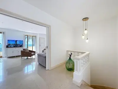 a living room with a vase in front of a mirror at Villa kriss in Nice
