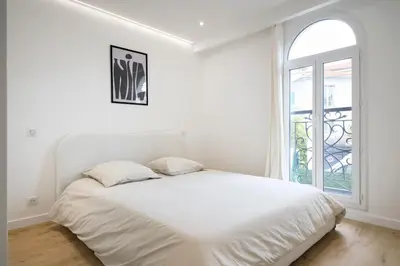 a white bedroom with a bed and a window at VILLA DES PERGOLAS -6 Bdrs - 5 bathrs -Parking -Jardin -JACUZZI -TRAMstation , 10 min beach in Nice
