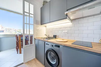 a kitchen with a washer and dryer in it at Appartement à 100m de la plage, climatisé in Cagnes-sur-Mer