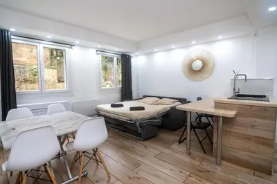 a room with a bed and a table and chairs at Bel appartement - Nice centre in Nice