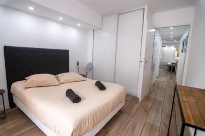 a bedroom with a large bed with a black headboard at Bel appartement - Nice centre in Nice