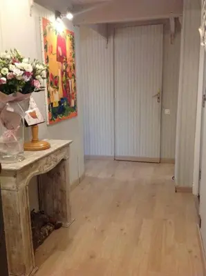 a room with a table with a vase of flowers on it at Charming apartment in Beaulieu sur Mer in Beaulieu-sur-Mer