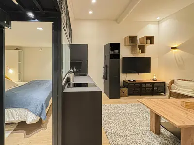 a kitchen and living room with a bed and a table at Old Town - 4 pers, AC in Nice