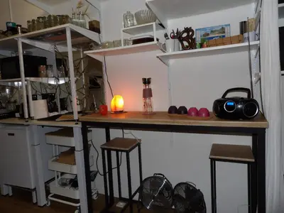 a kitchen with a counter and stools in a room at Studio japonisant in Nice