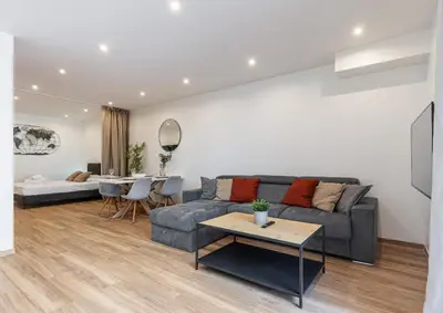 a living room with a couch and a table at LOFT à deux pas de la Mer avec terrasse n2 in Nice