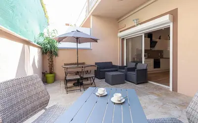 a living room with a blue table and chairs at LOFT à deux pas de la Mer avec terrasse n2 in Nice