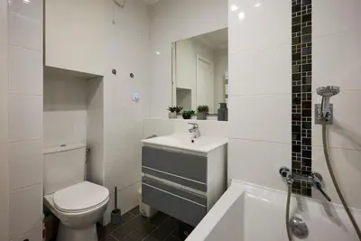 a white bathroom with a toilet and a sink at Moderne 2/3 Pièces près du Port in Nice