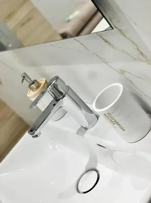 a sink with a faucet and a cup on it at Bright, newly renovated apartment in Nice