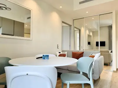 a living room with a white table and chairs at Bright, newly renovated apartment in Nice