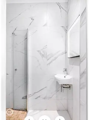 a white bathroom with a shower and a sink at Luxuriously furnished bright newly renovated oasis in Nice