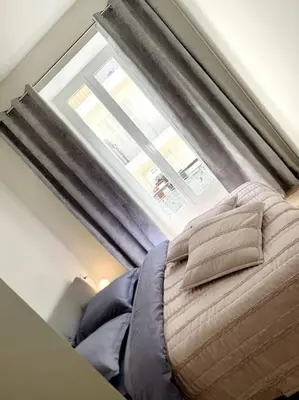 a window in a room with a bed in front of it at Luxuriously furnished bright newly renovated oasis in Nice