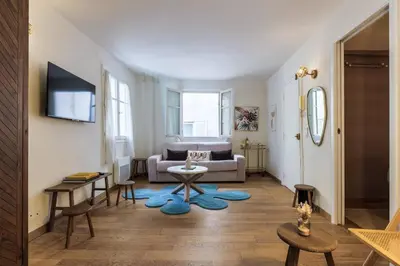 a living room with a couch and a table at Chic Old Town Apartment in Nice