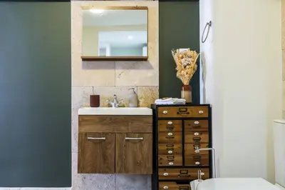 a bathroom with a sink and a mirror at Chic Old Town Apartment in Nice