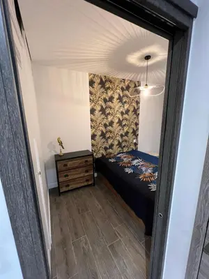 a small bedroom with a bed and a dresser at Port de Nice belle petite pépite in Nice