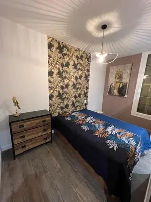 a bedroom with a bed and a dresser at Port de Nice belle petite pépite in Nice