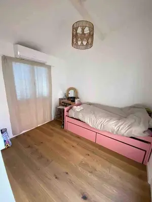 a bedroom with a pink bed and a window at Magnifique maison de pecheur face à la mer in Cagnes-sur-Mer