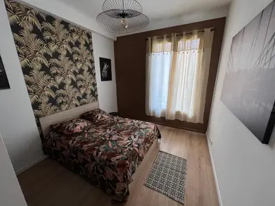 a bedroom with a bed and a large window at Belle perle rare port de Nice in Nice