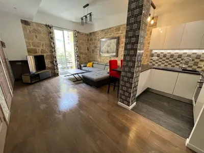 a kitchen and living room with a couch and a table at Belle perle rare port de Nice in Nice