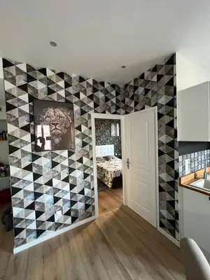 a kitchen with a checkered wall at Joyau rare port de Nice in Nice