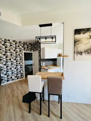 a dining room with a table and two chairs at Joyau rare port de Nice in Nice