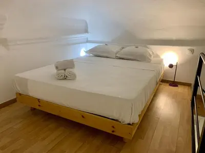 a bedroom with a large bed with towels on it at ApartHotel Riviera - DUPLEX DE JULES - Large Studio with A C - Old Town Promenade des An in Nice