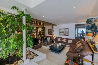 a living room with a couch and a plant at LOU MAS SOUBRAN VI2083 by RIVIERA HOLIDAY HOMES in Nice