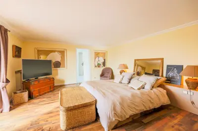 a bedroom with a large bed and a flat screen tv at LOU MAS SOUBRAN VI2083 by RIVIERA HOLIDAY HOMES in Nice