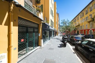 a street with a motorcycle parked next to a building at Nice Renting - GAUTIER - Elegance Height Port & Castle Nice in Nice