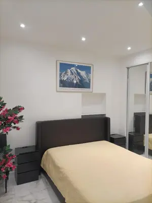 a bedroom with a bed and a picture on the wall at Appartement confortable a proximite de la mer. in Nice