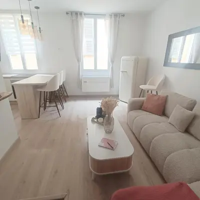 a living room with a couch and a table at Cocooning Atmosphère old Nice in Nice