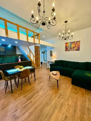a living room with a green couch and a table at Central Riviera Charm in Nice