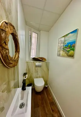 a bathroom with a white toilet and a sink at Central Riviera Charm in Nice