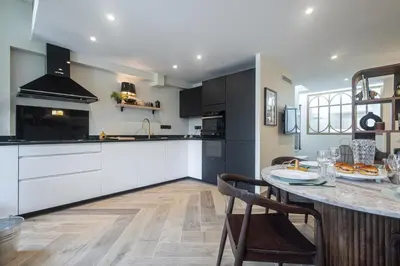 a kitchen with a table and a counter top at Villa fleurie in Cagnes-sur-Mer
