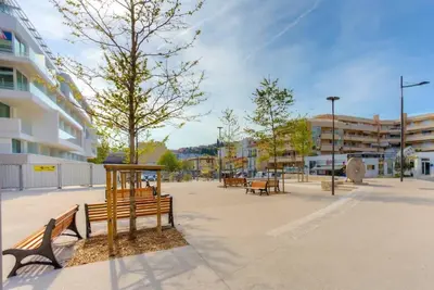 a group of park benches in a parking lot at Appartement en plein coeur de Cagnes sur Mer in Cagnes-sur-Mer