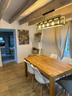 a dining room with a wooden table and white chairs at Villa de charme 6 Pièces avec Vue Mer sur les Hauteurs de Nice in Nice