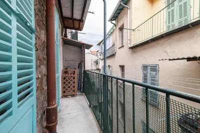 an alley with a blue door and a balcony at Pretty & Quiet Studio in Port Area in Nice