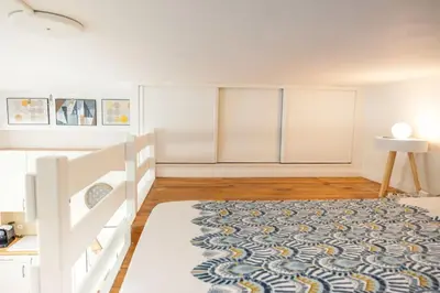 a bedroom with a bed and a rug on the floor at 50 meters from the beach ! Best location in Nice in Nice