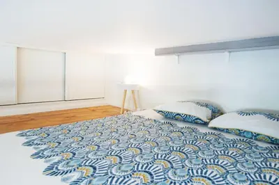 a bedroom with a large bed with two pillows at 50 meters from the beach ! Best location in Nice in Nice