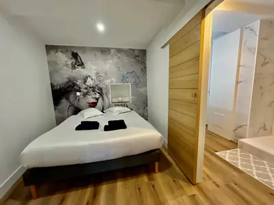 a bedroom with a bed with a painting on the wall at Old Town Lovely Apartment in Nice in Nice