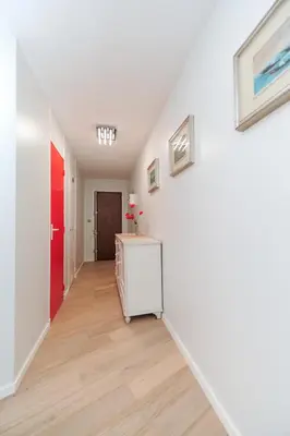 an empty hallway with a refrigerator and paintings on the wall at Blue Lagon Five Stars Holiday House in Nice