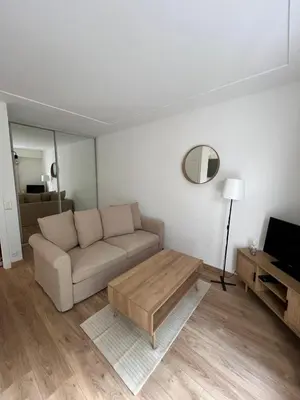 a living room with a couch and a coffee table at Studio centre-ville Beaulieu-sur-Mer in Beaulieu-sur-Mer