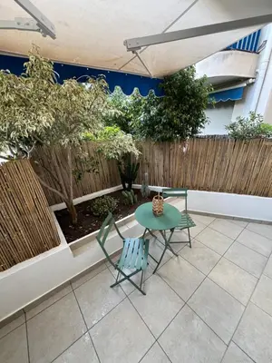 a patio with a table and chairs and a fence at Studio centre-ville Beaulieu-sur-Mer in Beaulieu-sur-Mer