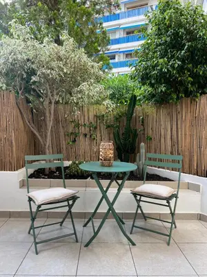 two chairs and a table and a table and chairs at Studio centre-ville Beaulieu-sur-Mer in Beaulieu-sur-Mer