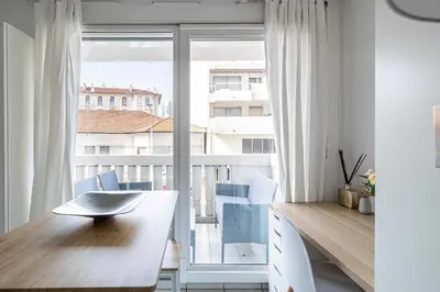 a room with a desk and a large window at Charming Studio with pool & balcony -Heart of Nice in Nice