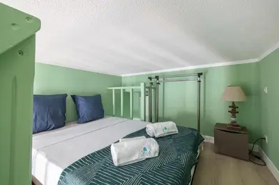 a bedroom with a bed with blue and green walls at MY CASA - SIAGRE 35 - Near main Avenue with AC in Nice