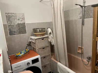 a small kitchen with a microwave and a shower at Nice center Aviva's-home in Nice